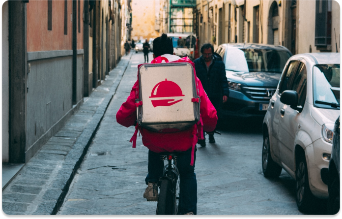 Foodora delivery person on a bicycle with a delivery box