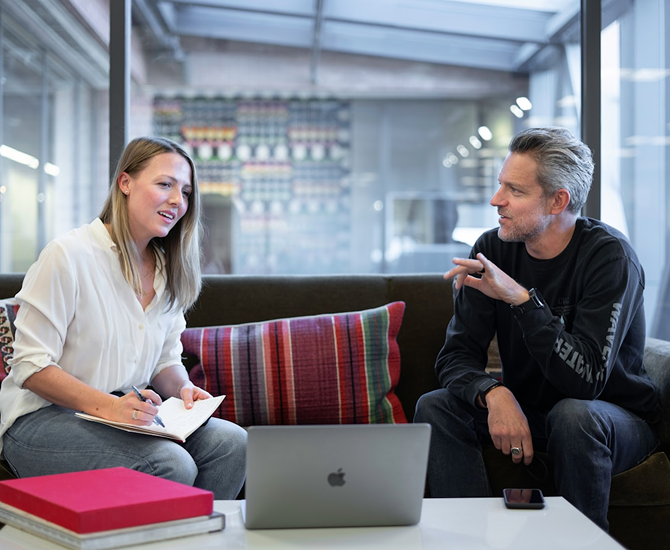 Two business professionals discussing web app development